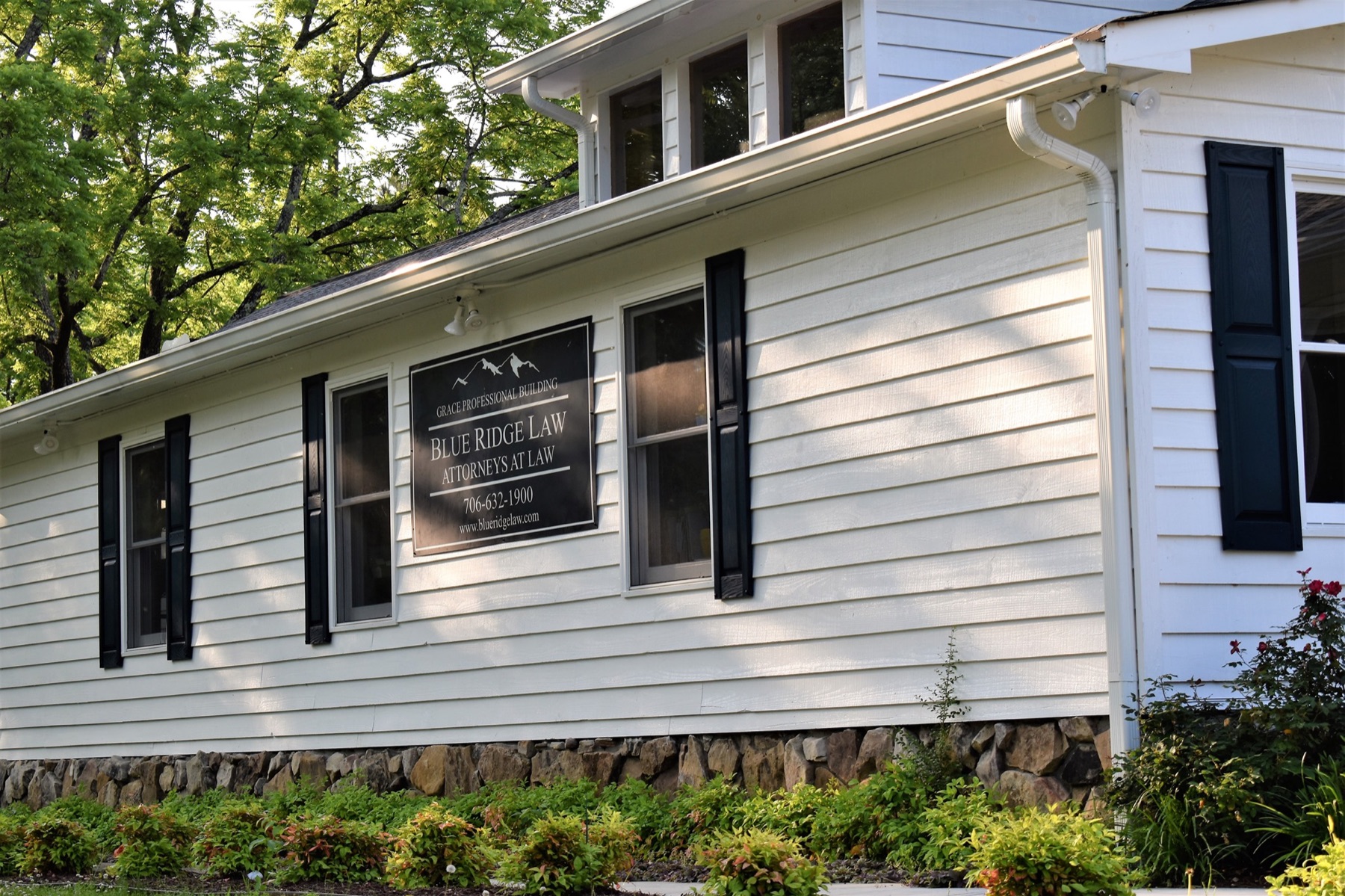The Blue Ridge Law office, a white clapboard building with black shutters on Old Highway 76