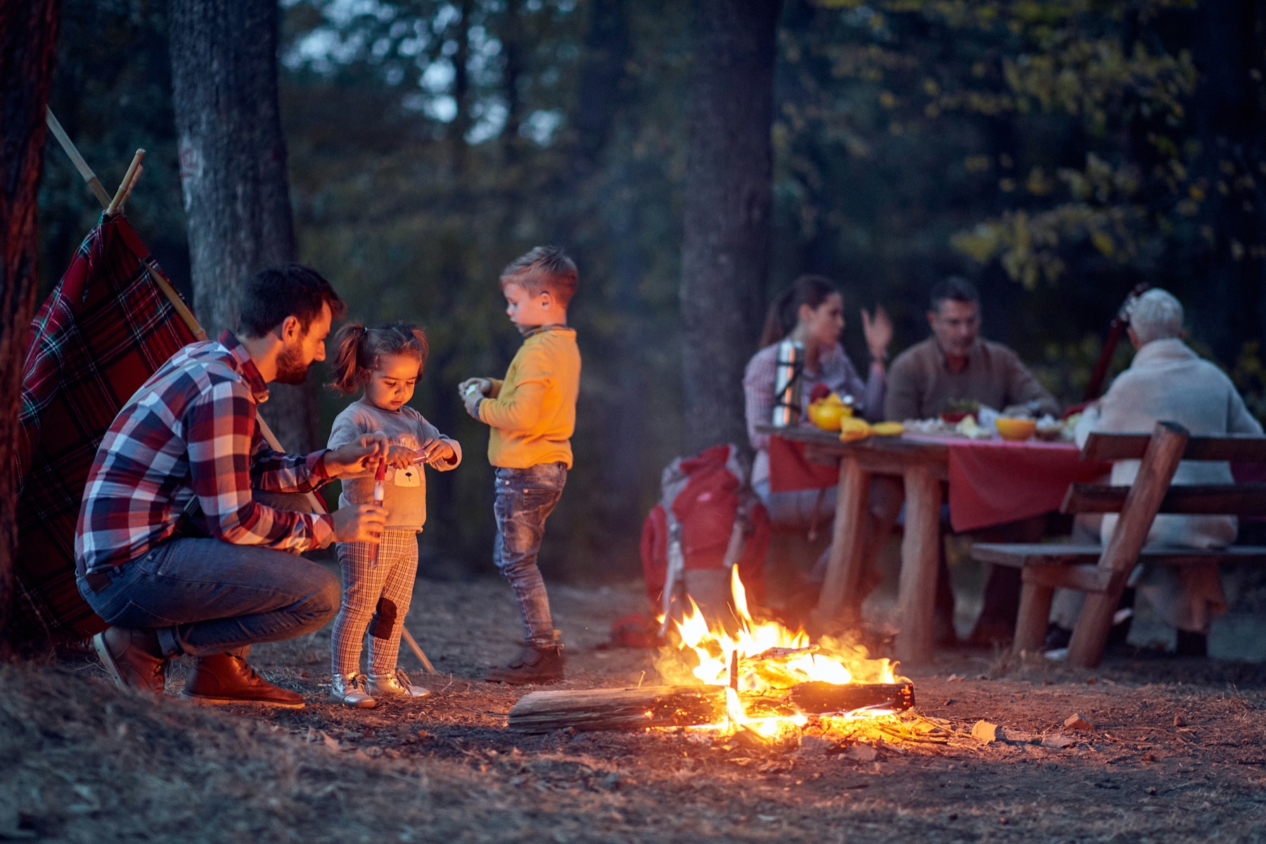 A family around a campfire in the North Georgia woods